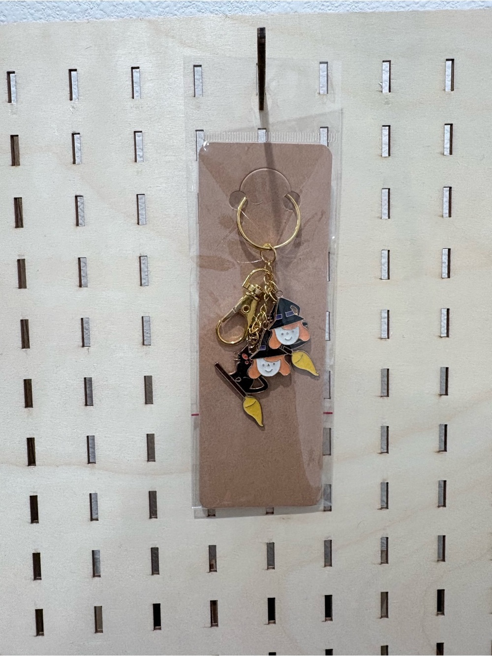 Handcrafted witch girl with a black cat charm keychain